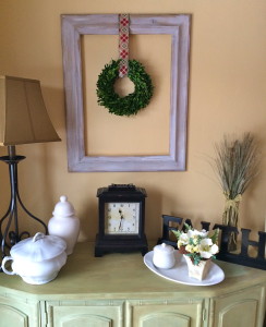 Boxwood wreath hung with Christmas ribbon